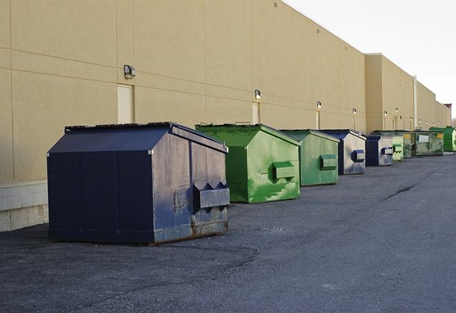 a row of blue construction dumpsters on a job site in Azusa